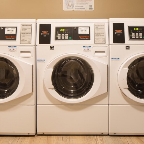 Laundry Room spacious room with multiple washer and dryer machines